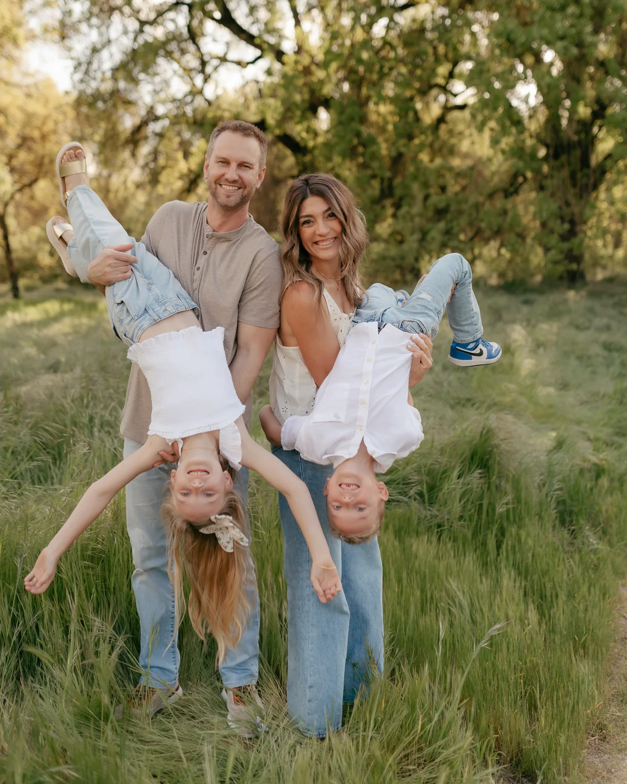 Dr. Becker and his family laughing together in a grassy field